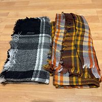 Both scarves side by side displaying colors, pattern and fringes