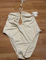 Full view of cream one-piece swimsuit front