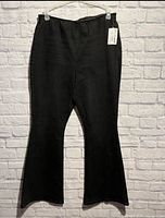 Full front view of black flared jeans