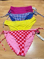 Four bikini bottoms laid out showing colours and styles