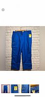 Full view of royal blue scrub pants hanging; shows overall style and new tag attached