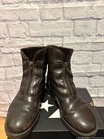 Front view of both boots showing leather uppers, zippers and toe condition