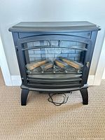 Front view showing glass door, log set, and control panel