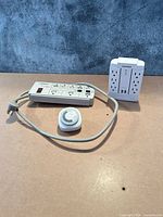 Lot overview showing CyberPower 6-outlet power strip, NOMA 24-hour timer