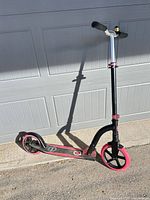 Side view of Globber kick scooter standing on pavement