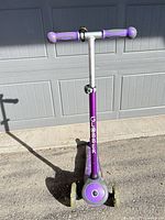 Front view of purple Globber three-wheel scooter