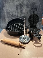 Group shot of all items: waffle maker, roasting pan with rack and lid, rolling pin, paper towel holder