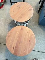 Two round wooden tabletops of IKEA ÄNGESBYN side tables