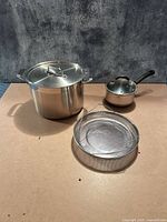 All items in lot: stock pot with lid, mesh strainer, saucepan