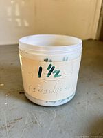 Plastic jar containing finishing nails with hand-written 1 1/2 label