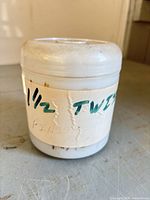 Plastic container labelled "1 1/2 TWIST" containing nails