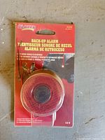 Front view of sealed BH2000 back-up alarm package showing product and branding