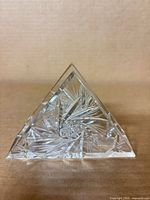 Front view of triangular cut crystal napkin holder showing pinwheel cuts