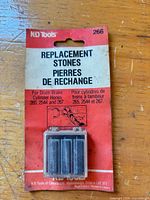 Front view of sealed KD Tools model 266 replacement hone stones package showing three stones and compatibility information