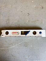 Front view of Lenox torpedo level showing three vials and ruler scale