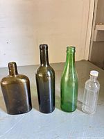 Group shot of all four bottles showing size, shape and color differences