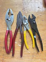 Group shot of all four pliers on workbench