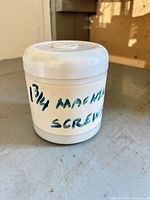 Closed plastic container labeled "1 3/4 machine screws"
