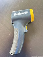 Left side view showing Mastercraft branding, blue body, yellow accent, grey dotted grip