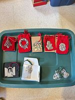 Overview of all ten pewter ornaments with pouches and cords