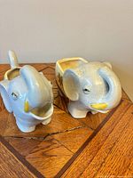 Both elephant planters showing overall form and size comparison