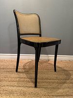 Side angle highlighting curved backrest and leg profile