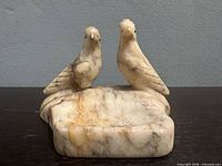 Front view of marble dish with two birds