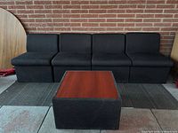 Front view showing four chairs aligned and coffee table