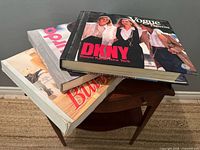 Stack of three sewing pattern catalogs showing Vogue DKNY cover, Burda grey spine, Butterick red lettering