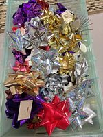 Top view of storage bin filled with assorted metallic gift bows