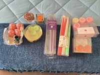 All items laid out: tapers, tea lights, novelty spheres, rose candle, holders