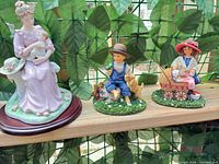 All three figurines together showing relative sizes and themes