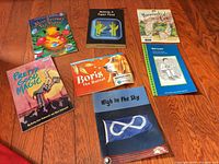 All seven paperback books laid out face up