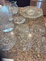 Group view showing platter with dip bowl, seven plates, pitcher and vase