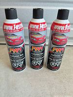 Front view of three FW1 Cleaning Wax aerosol cans
