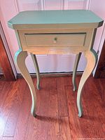 full view of green painted solid wood side table, front angle
