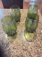 All four green stemless wine glasses on countertop