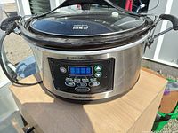 Front view showing stainless body, digital panel and lid
