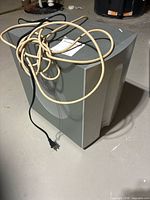 Front and top view of Infinity TSS-450 subwoofer with attached AC cord and speaker wire