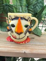 Front view of Tony the Tiger molded mug showing face details and paint wear