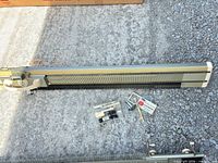 Full view of KnitKing flatbed knitting machine with accessory kit on ground