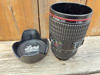 mug front view with lid beside, showing lens markings