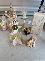 Group shot showing majority of angel figurines in various materials