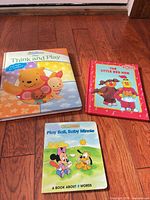 Front covers of three board books: Think and Play, The Little Red Hen, Play Ball Baby Minnie