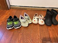 All four pairs of shoes lined up on floor