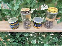 Group shot of two Planters tins and two glass jars with hardware