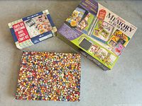 Overview of three boxed items: puzzle, craft kit, memory album kit