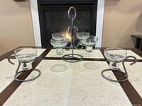 full view of metal stand with four glass cups