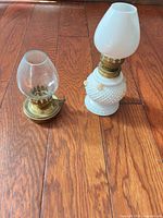 Both miniature oil lamps side by side showing scale, materials and chimneys