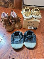All three pairs of Minimoc baby shoes with box